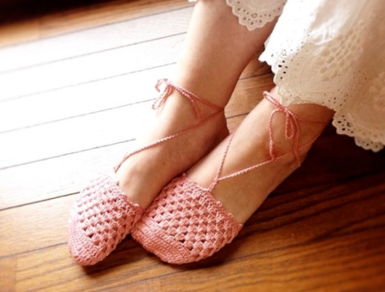 ピンクの毛糸で編まれた靴下を履いている。靴下は足先三分の一程度で、足首にはリボンがされている。